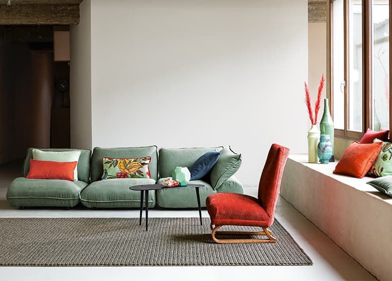 Grünes Sofa und ein roter Sessel