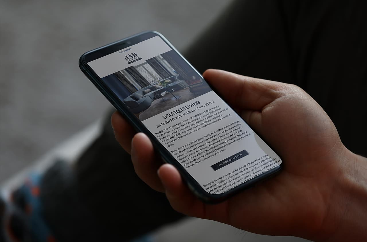 Smartphone with JAB ANSTOETZ Newsletter, Boutique Living collection page.