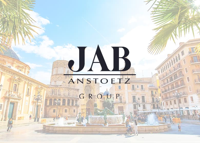 Eine Aufnahme von einer spanischen Stadt im Hintergrund und dem JAB ANSTOETZ-Logo im Vordergrund.
